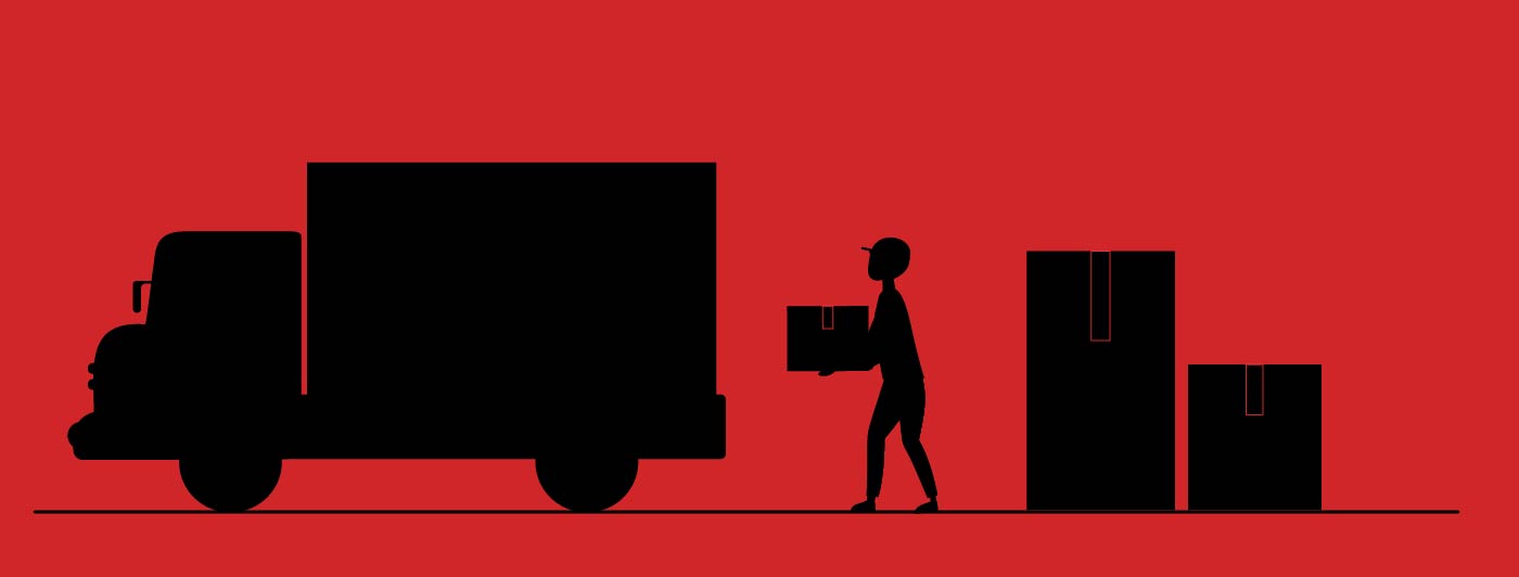 Delivery man loading heavy packages onto truck