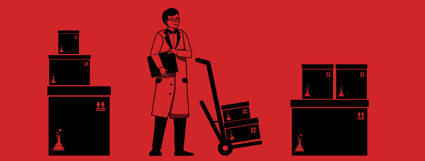 A pharmaceutical employee using a hand truck to more around inventory