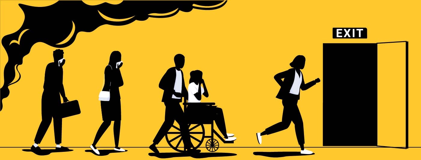 People moving towards an exit as they evacuate