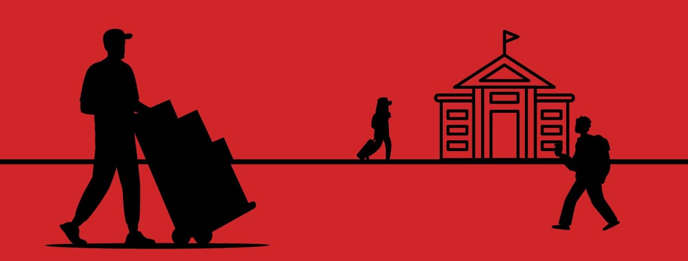 a person with a hand truck carrying items into to a college